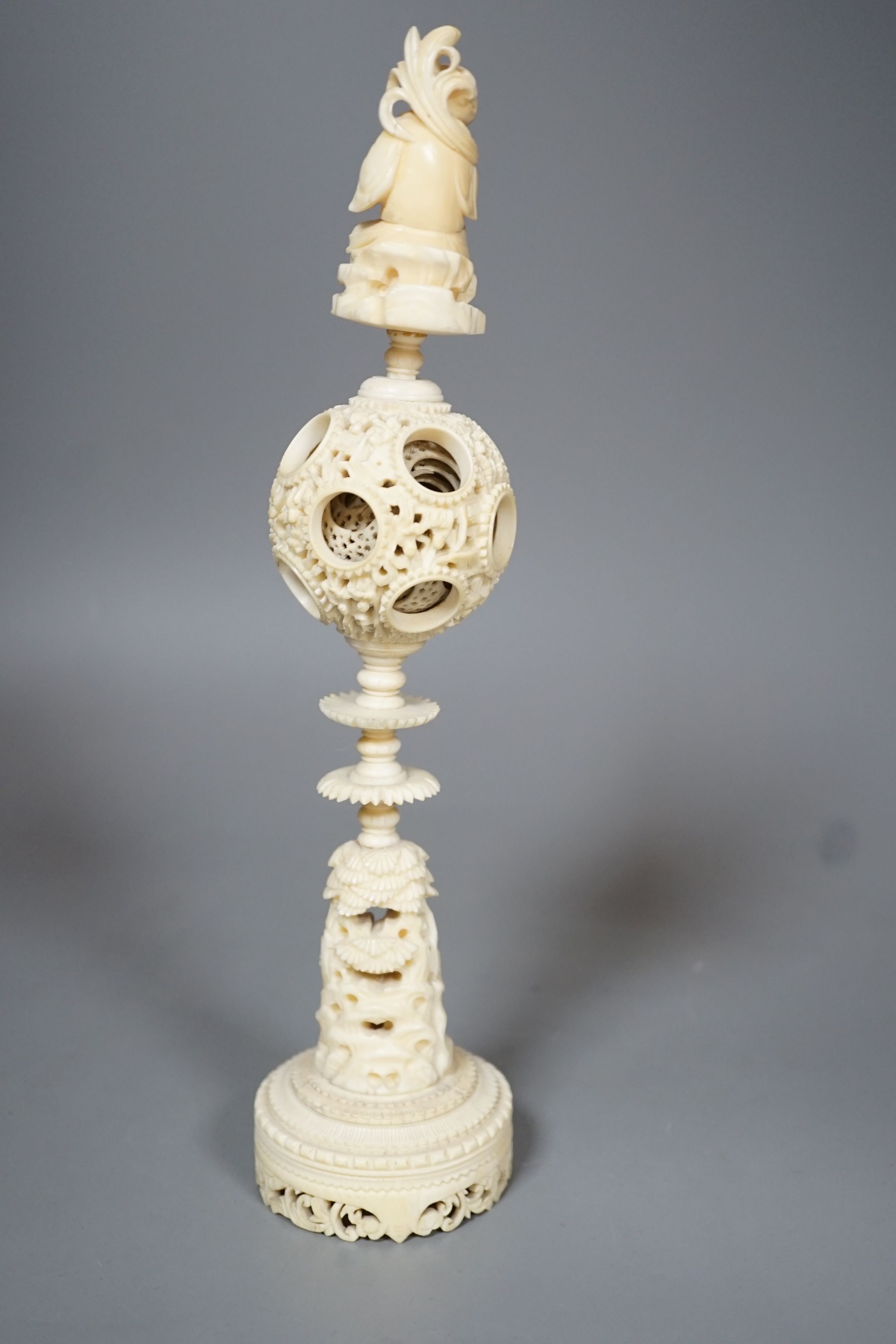 An early 20th century Chinese carved ivory concentric puzzle ball on stand 27cm